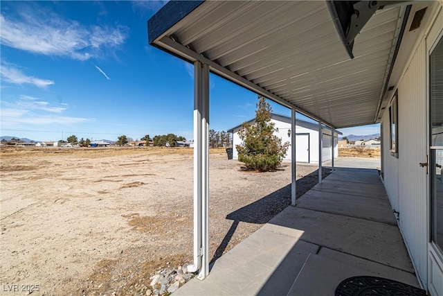 view of patio / terrace featuring an outbuilding and a storage shed