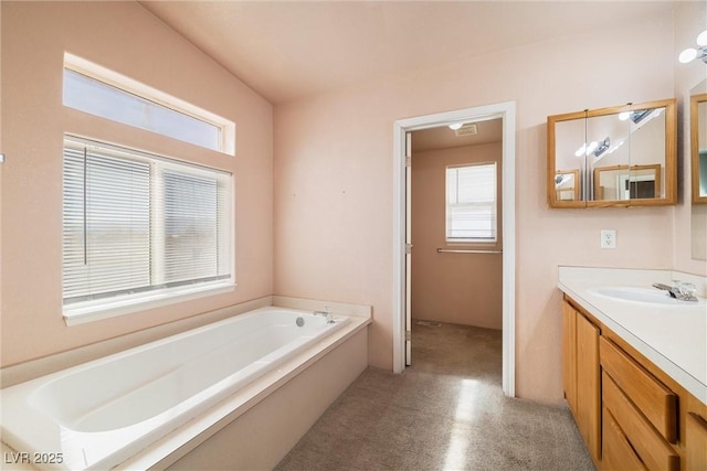 full bath with a garden tub, vanity, and carpet flooring