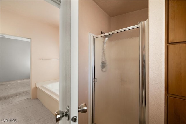 bathroom with a garden tub and a shower stall