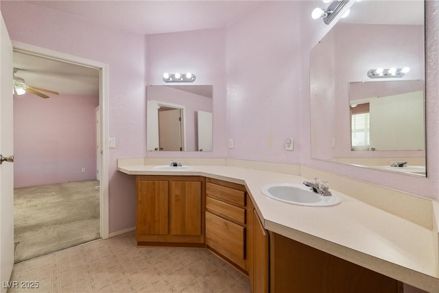 bathroom featuring double vanity, ceiling fan, a sink, and tile patterned floors