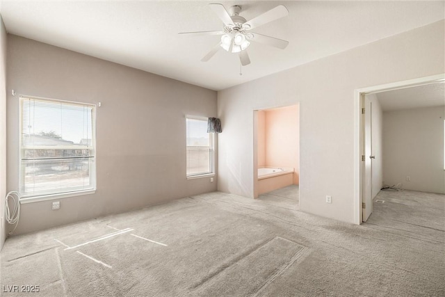 unfurnished bedroom featuring a ceiling fan, carpet, and ensuite bathroom