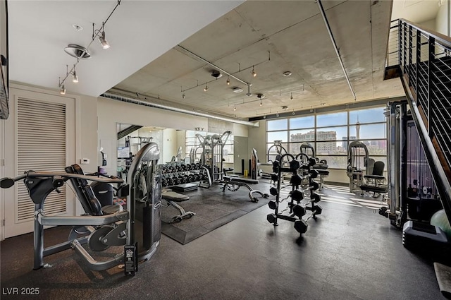 workout area featuring track lighting