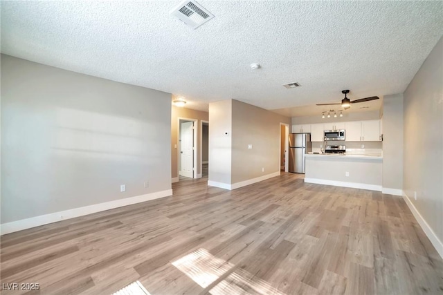 unfurnished living room featuring ceiling fan, visible vents, baseboards, and light wood-style flooring