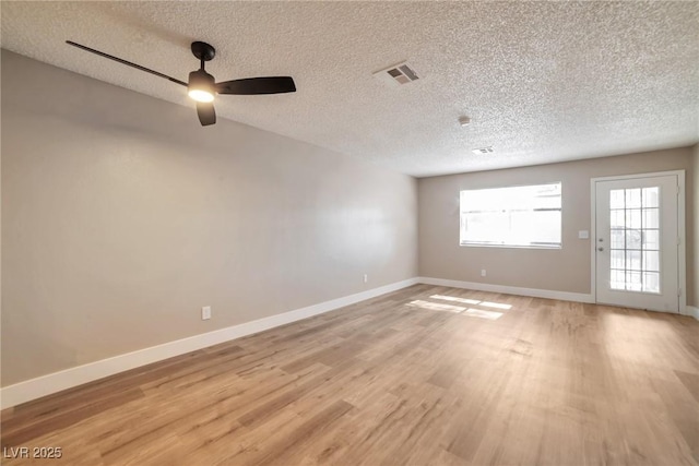 unfurnished room featuring visible vents, baseboards, and light wood-style flooring