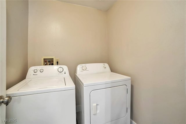 laundry room with separate washer and dryer and laundry area