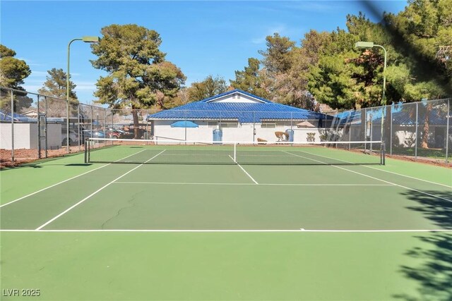 view of tennis court featuring fence