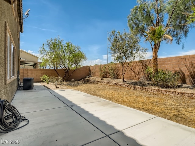 view of patio with cooling unit and a fenced backyard