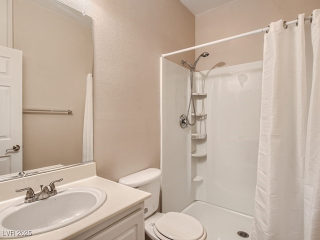 full bath with toilet, a shower stall, and vanity