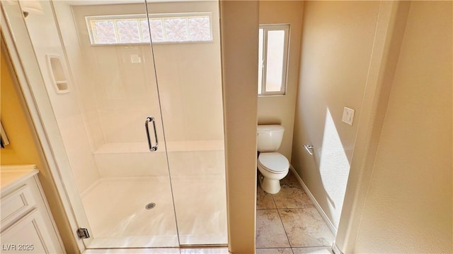 bathroom featuring a stall shower, tile patterned flooring, toilet, and baseboards