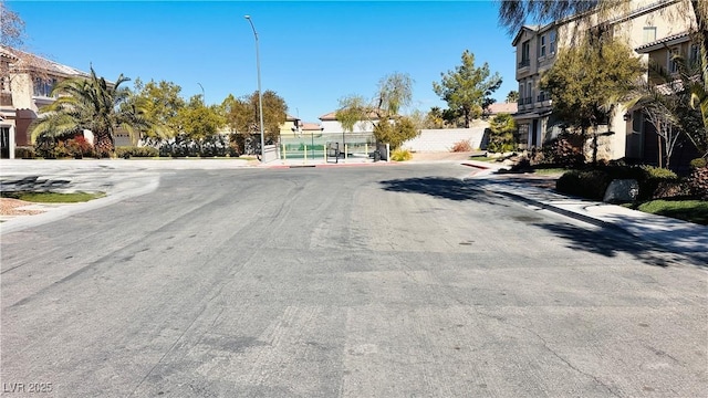 view of road featuring sidewalks and street lights