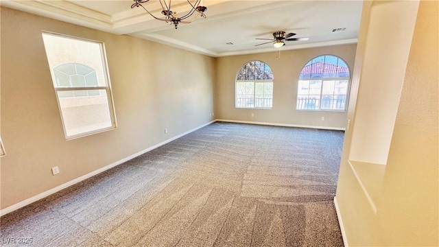 spare room featuring carpet floors, crown molding, visible vents, baseboards, and ceiling fan with notable chandelier