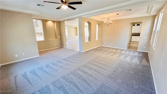 spare room with baseboards, a tray ceiling, visible vents, and light colored carpet