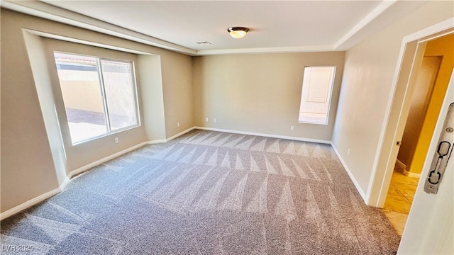 unfurnished room featuring visible vents, baseboards, and carpet flooring