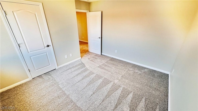 unfurnished bedroom with carpet floors and baseboards