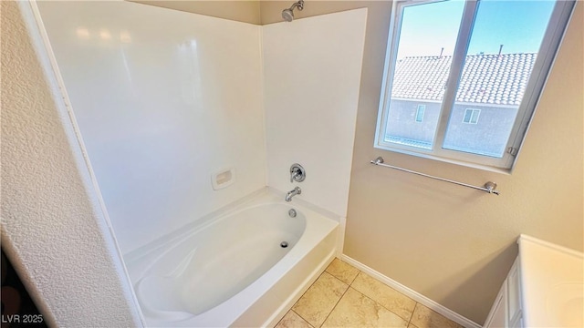 full bath featuring tile patterned flooring, baseboards, and shower / bathtub combination