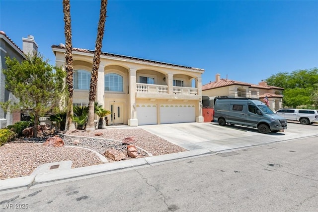 view of front of property featuring an attached garage, concrete driveway, and stucco siding