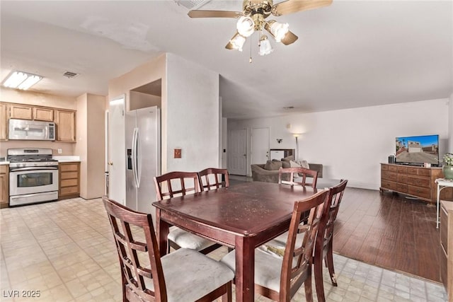 dining space with visible vents, ceiling fan, and light floors