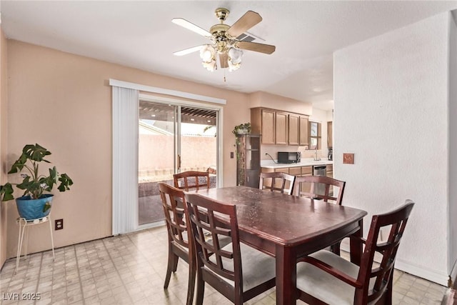 dining area with ceiling fan and light floors