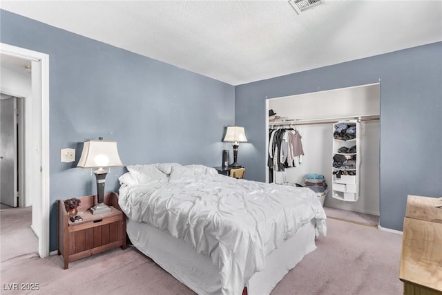 bedroom with a closet, carpet flooring, visible vents, and baseboards