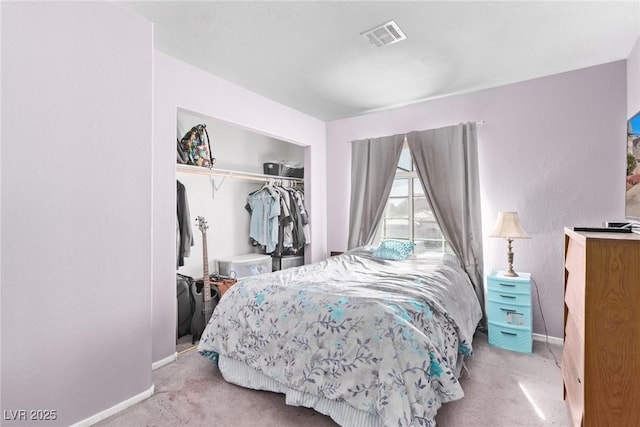 bedroom with a closet, carpet, visible vents, and baseboards