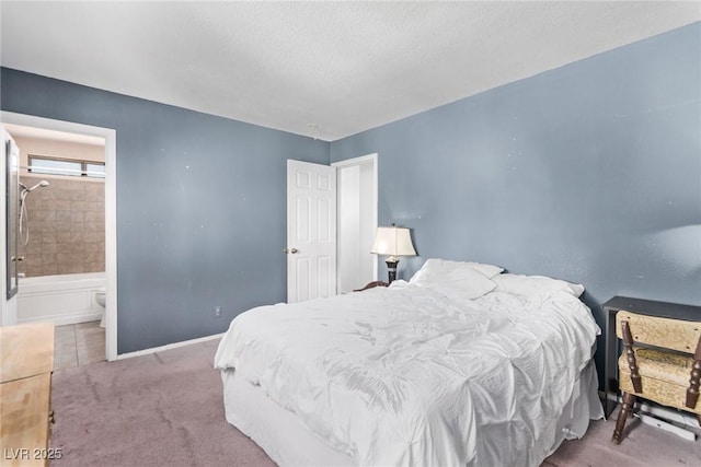 bedroom with carpet, ensuite bath, baseboards, and a textured ceiling