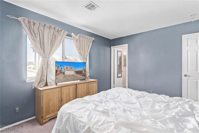 bedroom featuring light carpet, visible vents, and baseboards