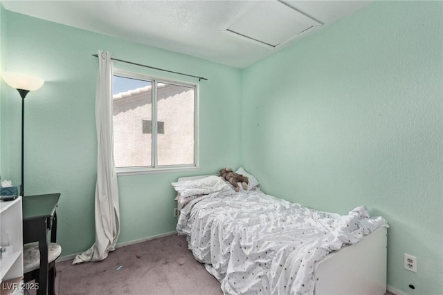 bedroom featuring attic access, carpet flooring, and baseboards