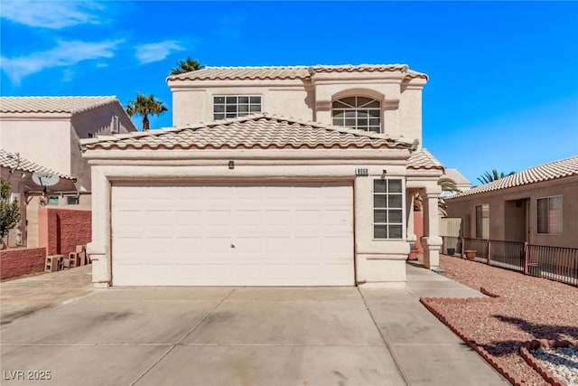 mediterranean / spanish house featuring a garage, driveway, a tiled roof, and stucco siding