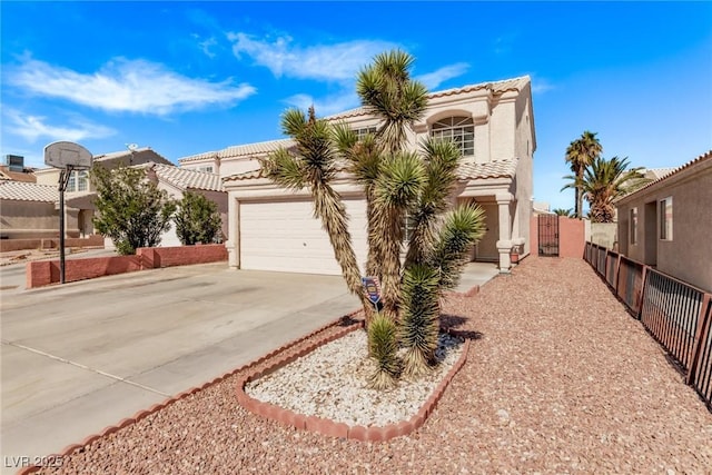 view of front of home with a garage, driveway, a tile roof, and stucco siding