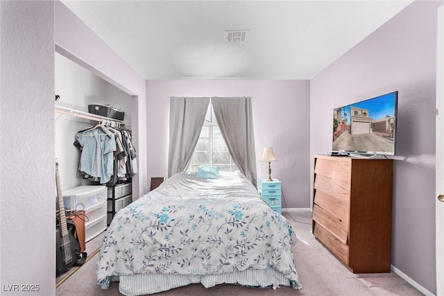 bedroom with carpet, a closet, visible vents, and baseboards