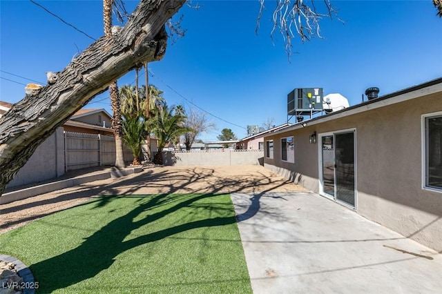 view of yard with a patio area, a fenced backyard, and cooling unit