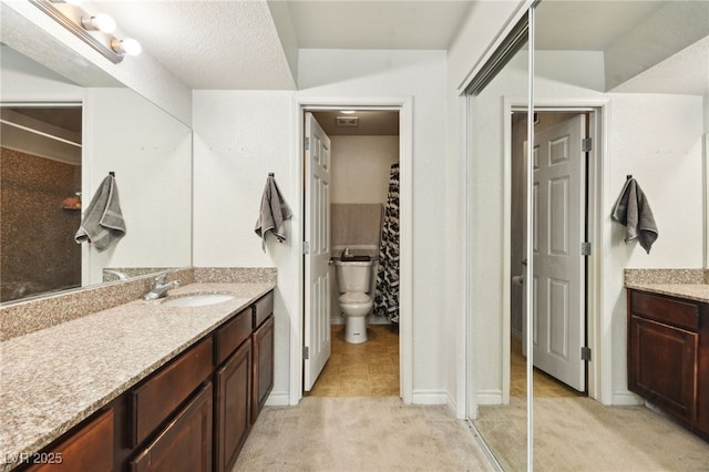 bathroom with curtained shower, visible vents, vanity, and toilet