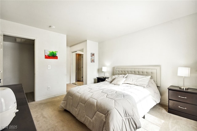 bedroom with baseboards, a closet, and light colored carpet