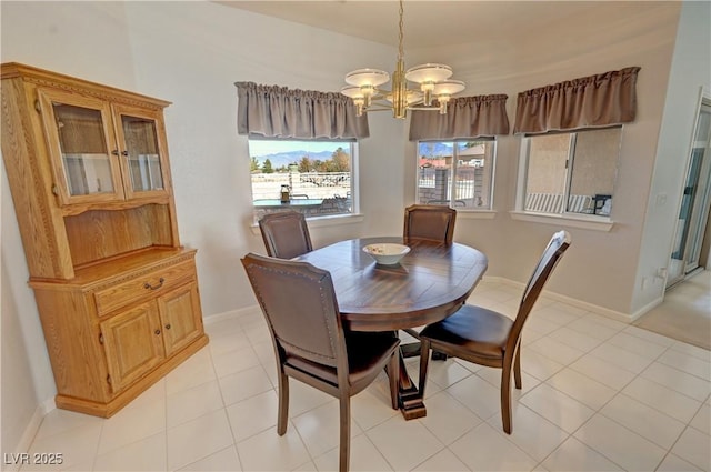 dining space with light tile patterned floors, baseboards, and a notable chandelier