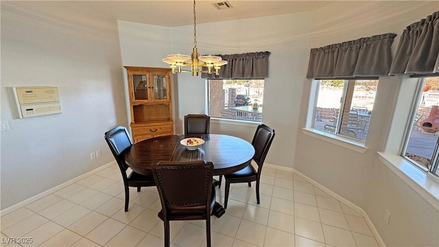 dining room with visible vents, a notable chandelier, baseboards, and light tile patterned flooring