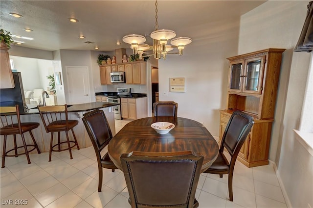 dining space featuring light tile patterned floors, baseboards, a notable chandelier, and recessed lighting