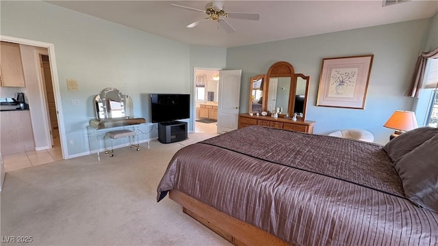 bedroom with visible vents, light carpet, ceiling fan, ensuite bath, and baseboards