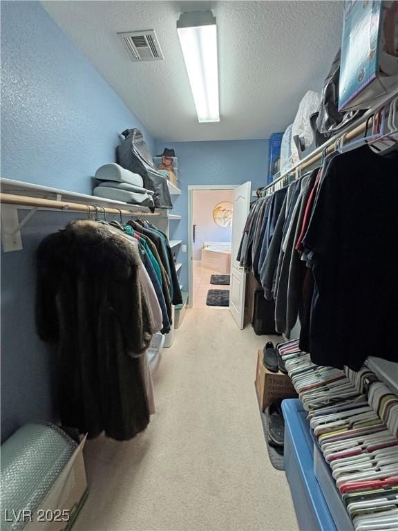 spacious closet with visible vents and light carpet