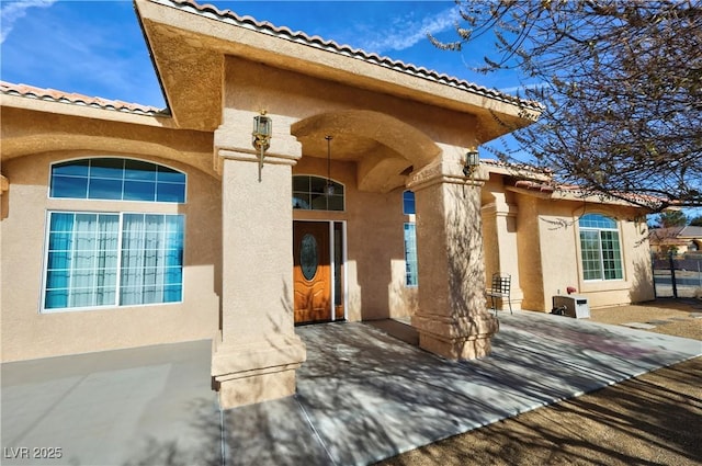 entrance to property featuring stucco siding