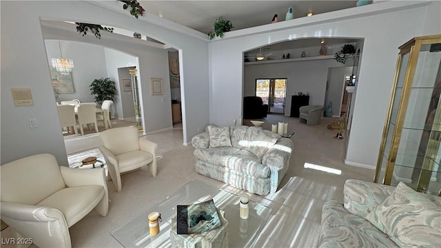 carpeted living room with arched walkways