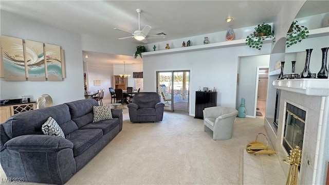 living area with light tile patterned floors, light carpet, ceiling fan, and a premium fireplace