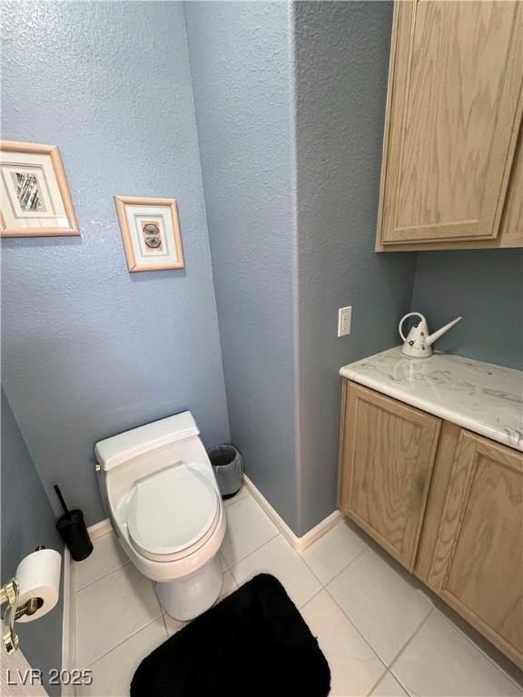 bathroom with toilet and tile patterned flooring