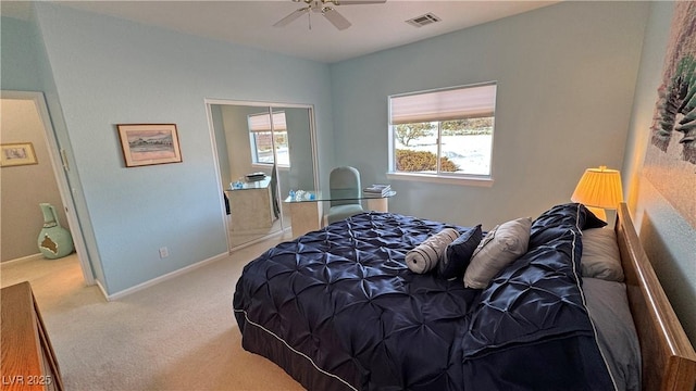 carpeted bedroom with a ceiling fan, visible vents, and baseboards