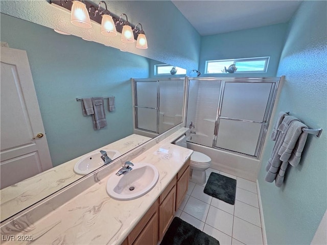 bathroom with shower / bath combination with glass door, vanity, toilet, and tile patterned floors