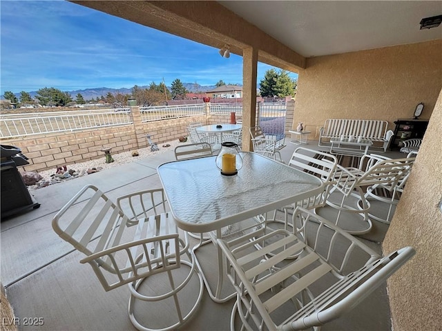 view of patio / terrace featuring outdoor dining space and a mountain view