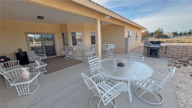 view of patio / terrace with outdoor dining space, area for grilling, and fence