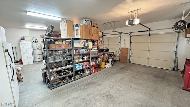 garage with freestanding refrigerator and a garage door opener