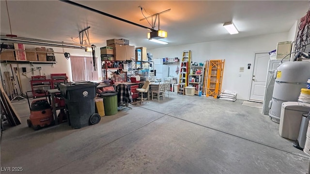 garage with a garage door opener and a workshop area