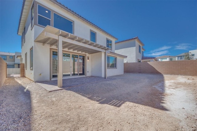 back of property with a patio area, a fenced backyard, a tiled roof, and stucco siding