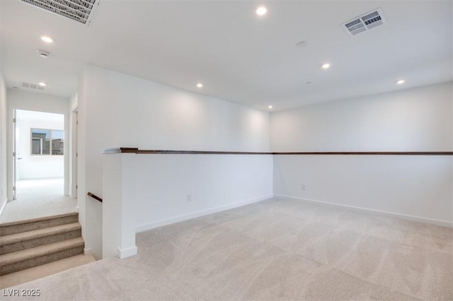 unfurnished room with recessed lighting, visible vents, and light colored carpet